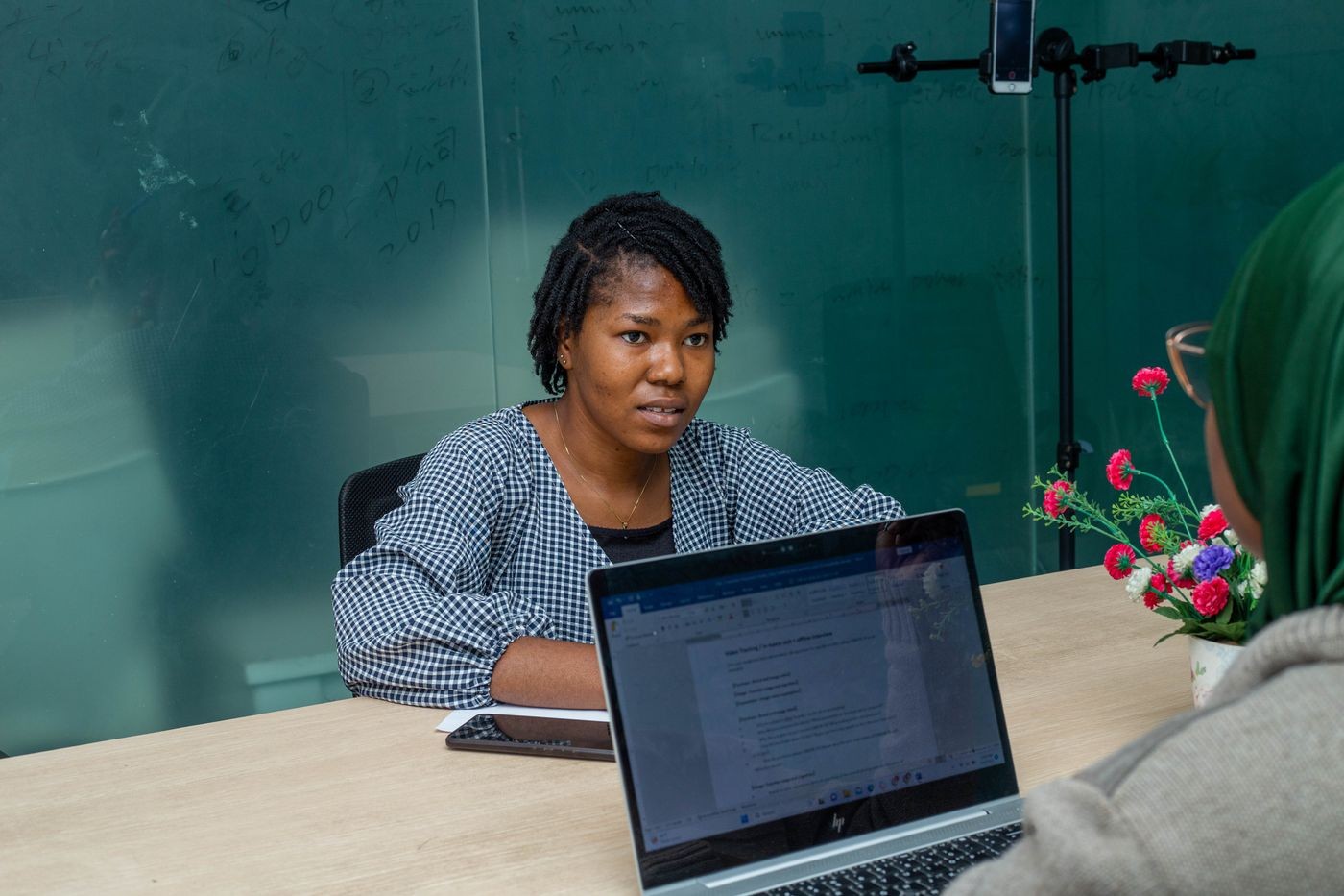 Young woman at a laptop reviewing her CV